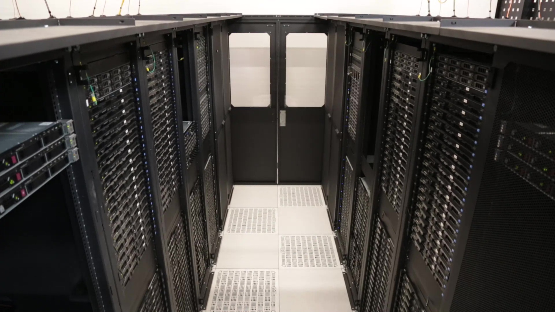 Rows of servers in a data center, the infrastructure behind open-weight AI models