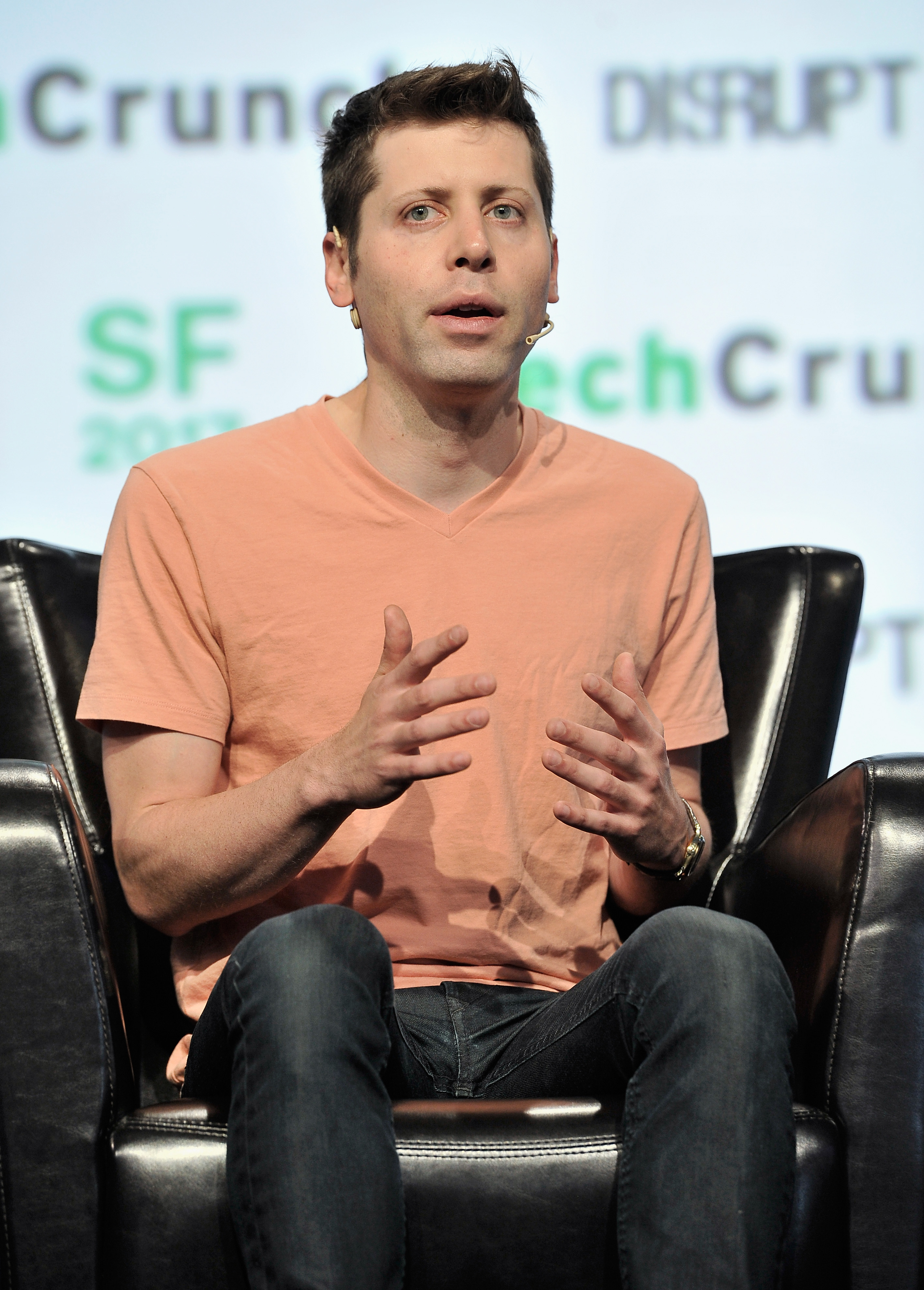 Sam Altman speaking on stage at TechCrunch Disrupt in 2017